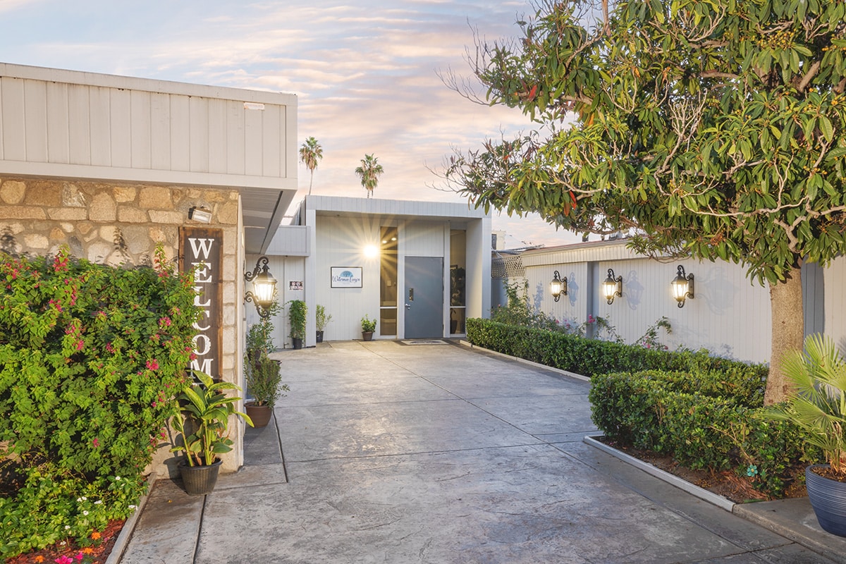 Entrance to facility with welcome sign and lanterns