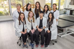 Group of medical and physical therapy staff in white lab coats