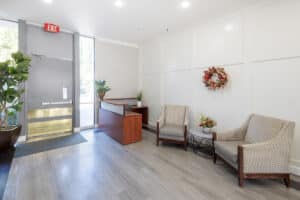 Lobby of facility with beautiful brown chairs and wainscotting walls