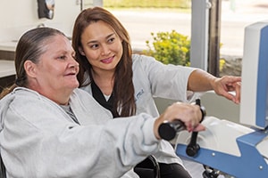 a rehab therapist with a resident in the gym at Waterman Canyon
